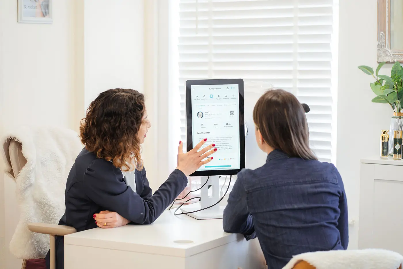 Aline Brito reviewing a digital skin analysis with a client